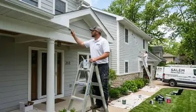 Professional house painters working on exterior home in Kenosha, WI