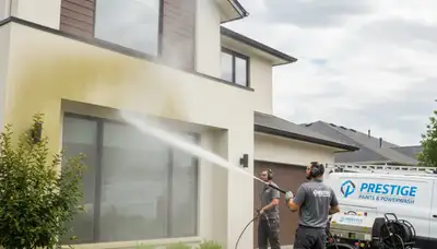Professional pressure washing a Kenosha WI home exterior removing dirt, salt, and lake moisture buildup